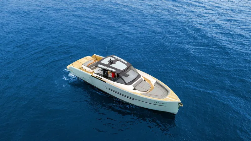  Yacht Photos Pics 2025 OKEAN 57 yacht cruising on clear blue ocean waters.