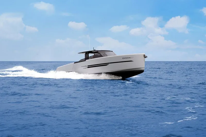  Yacht Photos Pics 2025 OKEAN 57 yacht cruising on open sea under clear blue sky.