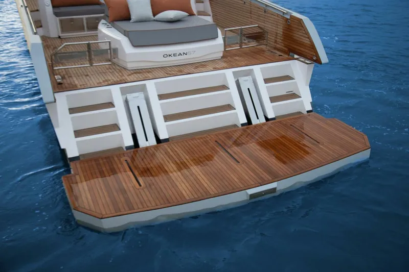  Yacht Photos Pics Luxury OKEAN 57 yacht's teak swim platform, 2025 model, on calm blue water.