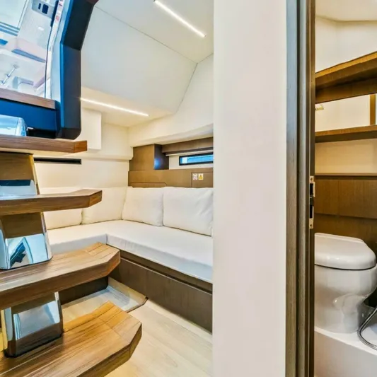  Yacht Photos Pics Luxurious interior of 2025 OKEAN 57 yacht featuring modern seating and bathroom.