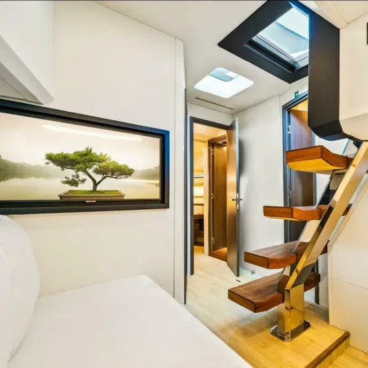  Yacht Photos Pics Luxurious interior of 2025 OKEAN 57 yacht with modern staircase and scenic artwork.