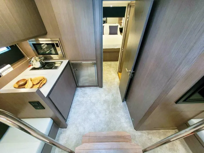 Yacht Photos Pics Modern kitchen interior on 2025 OKEAN 57 yacht, featuring sleek cabinetry and appliances.