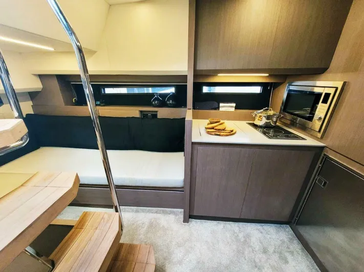  Yacht Photos Pics Modern interior of 2025 OKEAN 57 yacht with kitchenette and seating area.