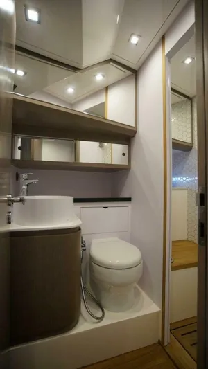  Yacht Photos Pics Modern bathroom in 2025 OKEAN 57 yacht, featuring sleek fixtures and ambient lighting.