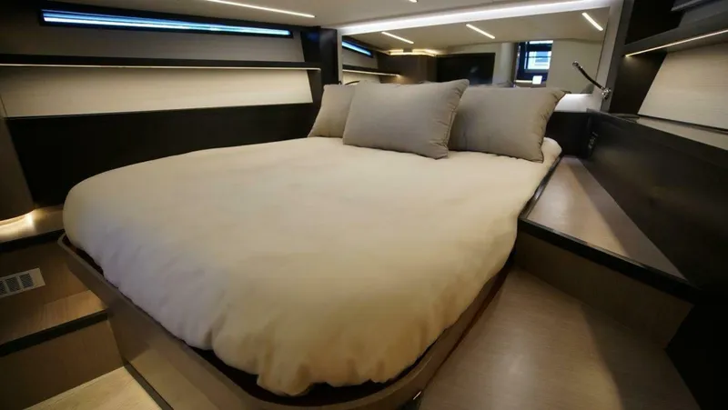  Yacht Photos Pics Luxurious bedroom interior of 2025 OKEAN 57 yacht with modern design and cozy bedding.