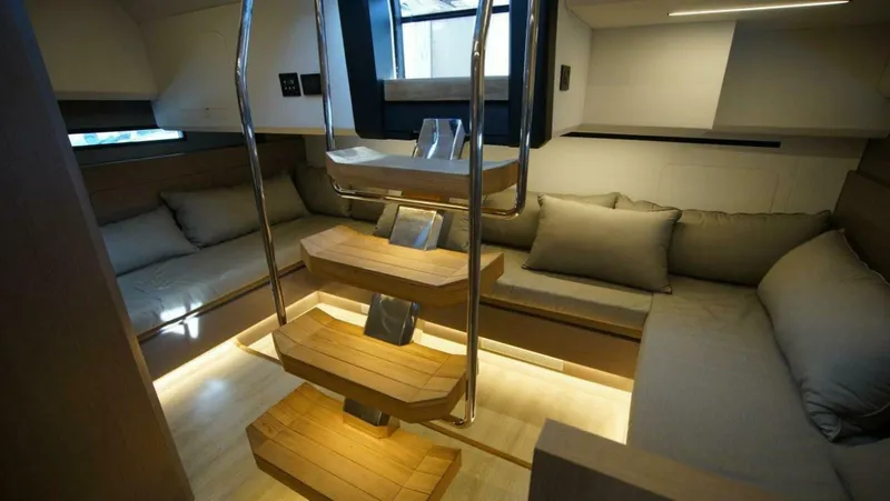  Yacht Photos Pics Luxurious interior of 2025 OKEAN 57 yacht with modern seating and wooden staircase.