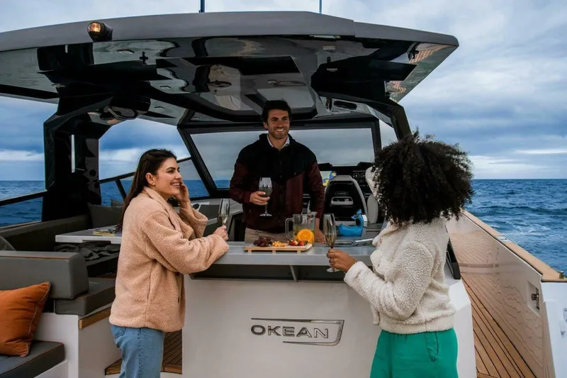  Yacht Photos Pics Three people enjoying drinks on a 2025 OKEAN 57 yacht.