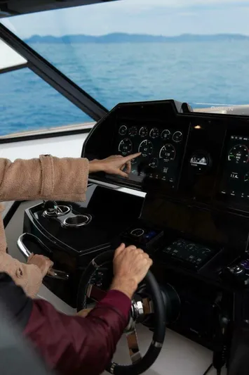  Yacht Photos Pics People navigating a 2025 OKEAN 57 yacht on open water.