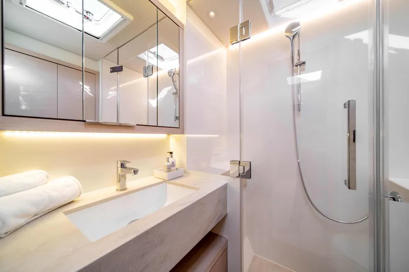  Yacht Photos Pics Luxurious bathroom in 2026 Lagoon 55 yacht, featuring modern fixtures and elegant design.
