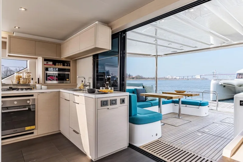  Yacht Photos Pics Modern kitchen and dining area on 2026 Lagoon 55 yacht with scenic water view.