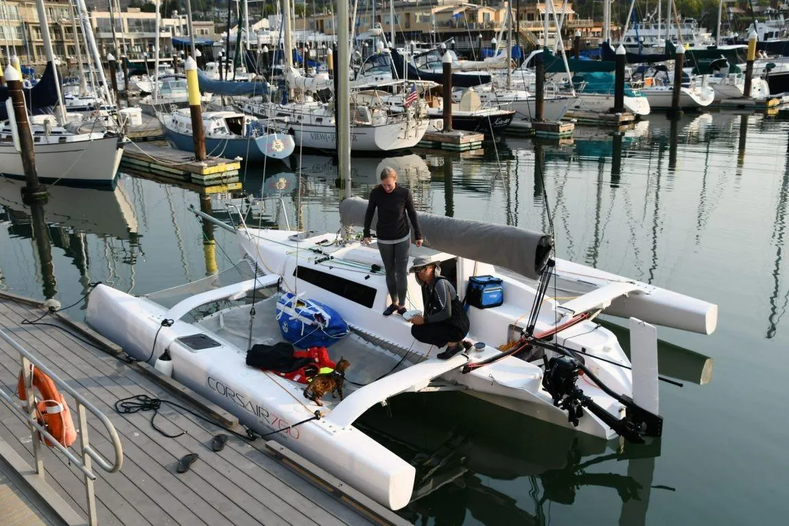 Corsair 760 Dash 2018 trimaran docked at marina with two people onboard.