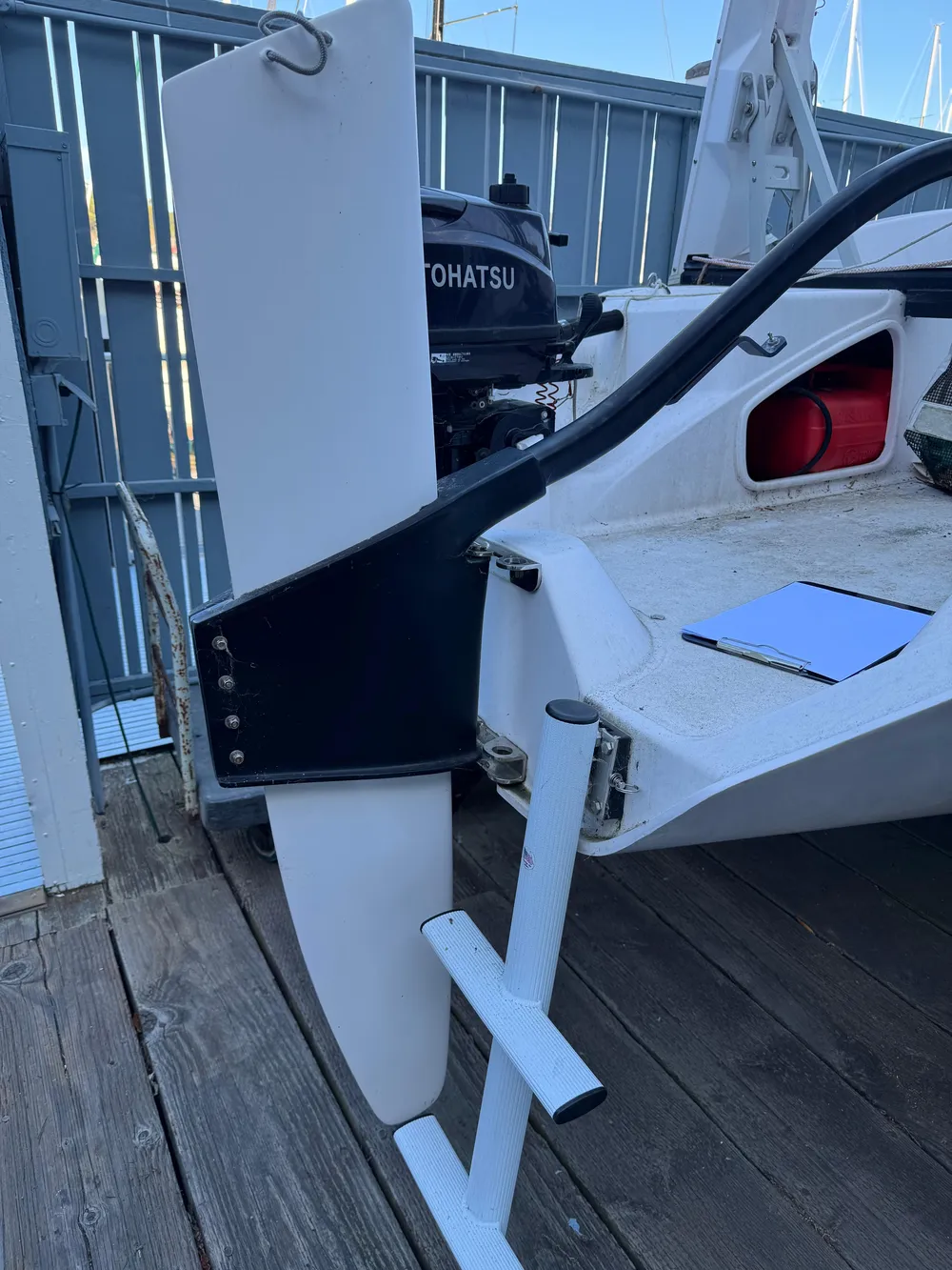 2018 Corsair 760 Sport boat with Tohatsu motor, docked with visible rudder and ladder.
