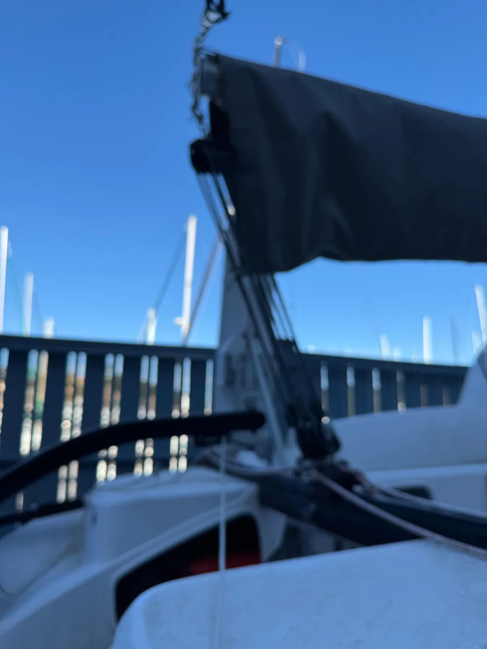 2018 Corsair 760 Sport sailboat with rigging, docked under clear blue sky.