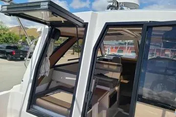  Yacht Photos Pics 2023 Cutwater C-248 Coupe boat interior with open doors, showcasing seating and dashboard.