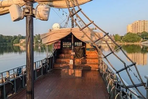  Yacht Photos Pics Custom 2016 pirate ship on calm water, featuring wooden deck and rigging, with cityscape background.