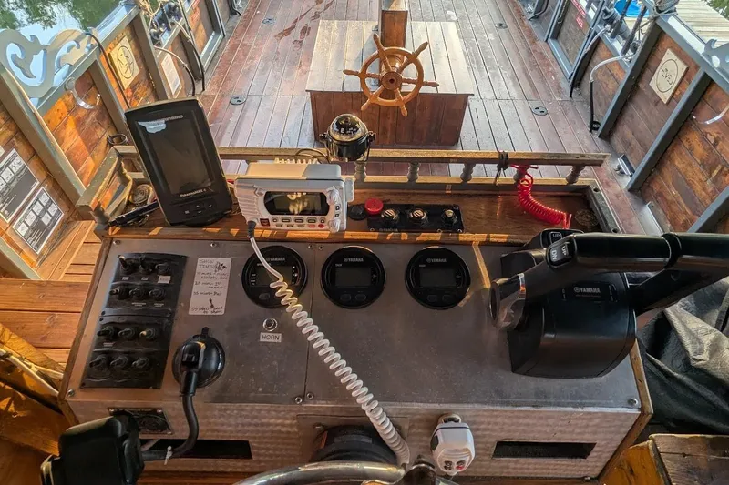  Yacht Photos Pics Control panel of a 2016 custom pirate ship with steering wheel and navigation equipment.