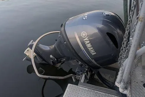  Yacht Photos Pics Outboard motor on a custom 2016 pirate ship, docked on calm water.