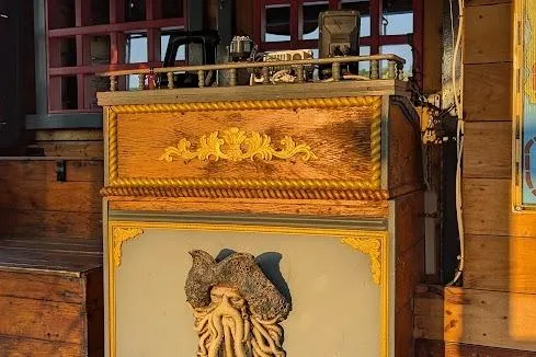  Yacht Photos Pics Decorative wooden panel on a 2016 custom pirate ship, featuring intricate carvings and nautical motifs.