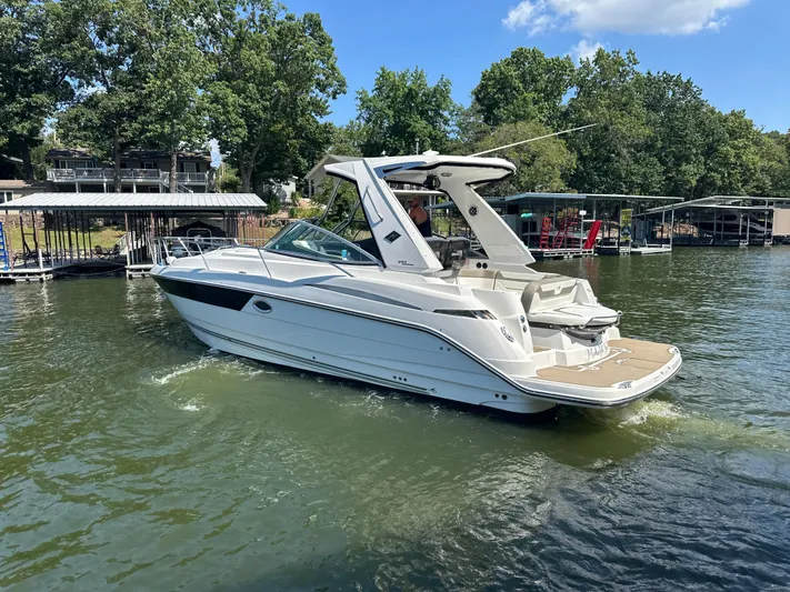  Yacht Photos Pics 2017 Monterey 355 Sport Yacht on a lake, surrounded by docks and trees.