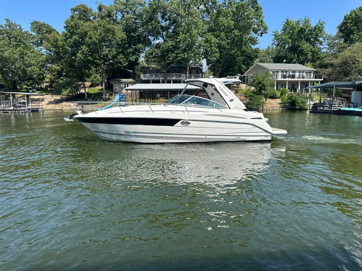  Yacht Photos Pics 2017 Monterey 355 Sport Yacht on a serene lake with lush greenery.