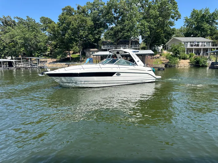  Yacht Photos Pics 2017 Monterey 355 Sport Yacht on a serene lake with lush greenery.