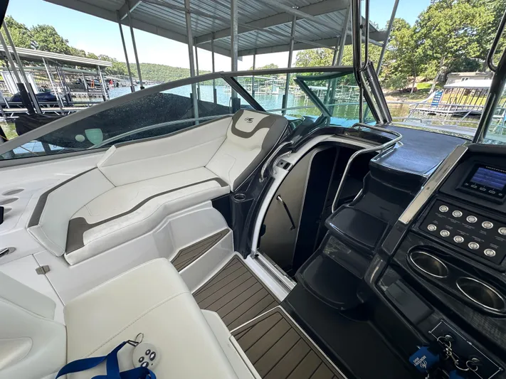  Yacht Photos Pics 2017 Monterey 355 Sport Yacht interior with white seating and control panel, docked at marina.