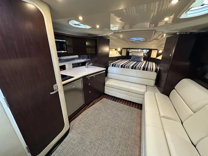  Yacht Photos Pics Luxurious interior of 2017 Monterey 355 Sport Yacht with modern kitchen and cozy seating area.
