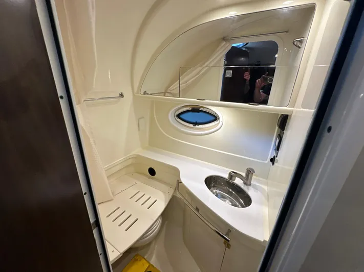  Yacht Photos Pics 2017 Monterey 355 Sport Yacht bathroom with sink, mirror, and porthole window.