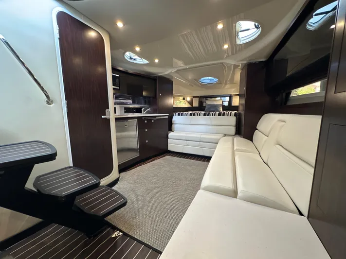  Yacht Photos Pics Luxurious interior of 2017 Monterey 355 Sport Yacht with modern seating and kitchenette.