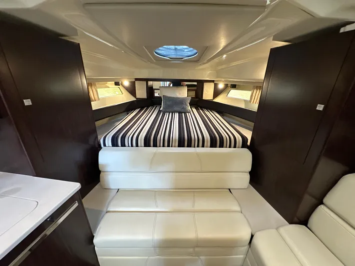  Yacht Photos Pics Luxurious interior of 2017 Monterey 355 Sport Yacht with striped bedding and plush seating.