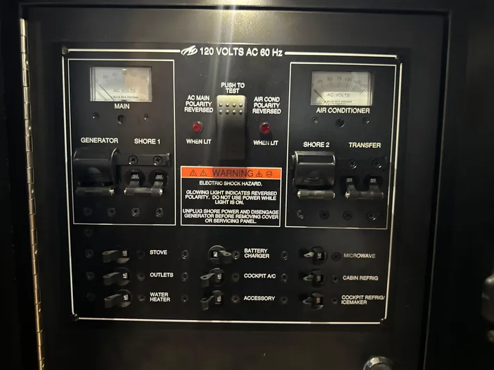  Yacht Photos Pics Electrical control panel of a 2017 Monterey 355 Sport Yacht, featuring various switches and warnings.