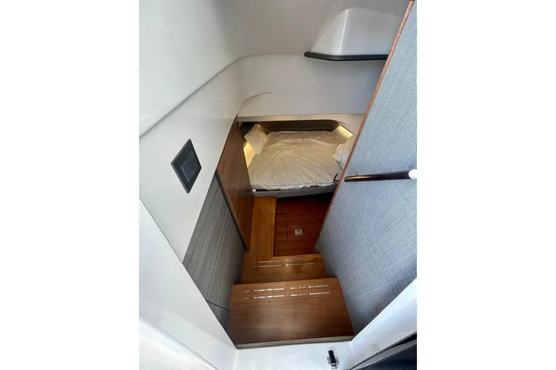  Yacht Photos Pics 2021 Tiara Yachts 34 LS cabin interior with wooden steps and cozy bed.
