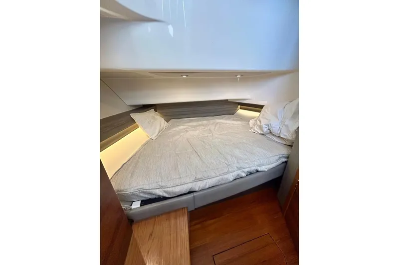  Yacht Photos Pics 2021 Tiara Yachts 34 LS cabin interior with cozy bed and ambient lighting.