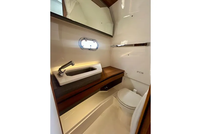  Yacht Photos Pics 2021 Tiara Yachts 34 LS bathroom with modern sink, toilet, and mirror.