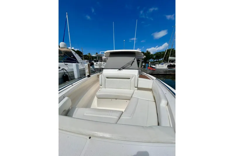  Yacht Photos Pics 2021 Tiara Yachts 34 LS boat with spacious seating, docked under clear blue sky.