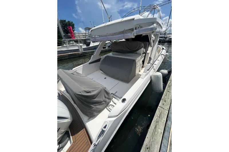  Yacht Photos Pics 2021 Tiara Yachts 34 LS docked, featuring covered seating and sleek design.