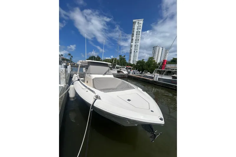  Yacht Photos Pics 2021 Tiara Yachts 34 LS docked, with cityscape and blue sky background.