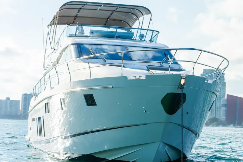 Blessed Yacht Photos Pics Luxury Fairline Squadron 65 yacht from 2015 on water, city skyline in background.