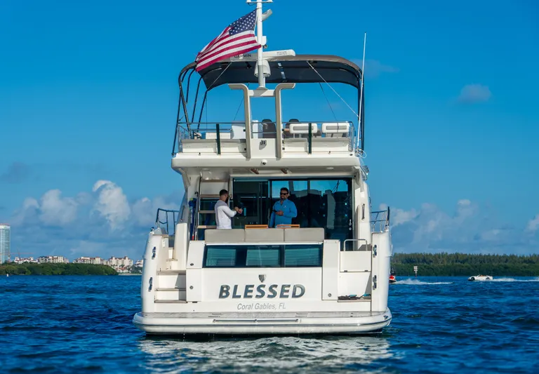 Blessed Yacht Photos Pics 2015 Fairline Squadron 65 yacht on water, rear view with American flag.