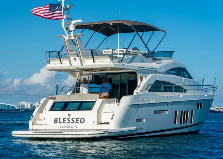 Blessed Yacht Photos Pics Luxury Fairline Squadron 65 yacht, 2015 model, cruising with American flag in coastal waters.