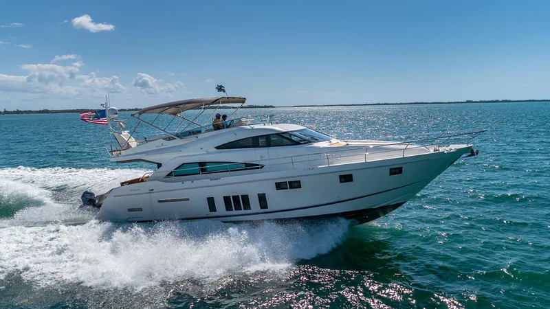 Blessed Yacht Photos Pics Luxury 2015 Fairline Squadron 65 yacht cruising on open sea under clear blue sky.