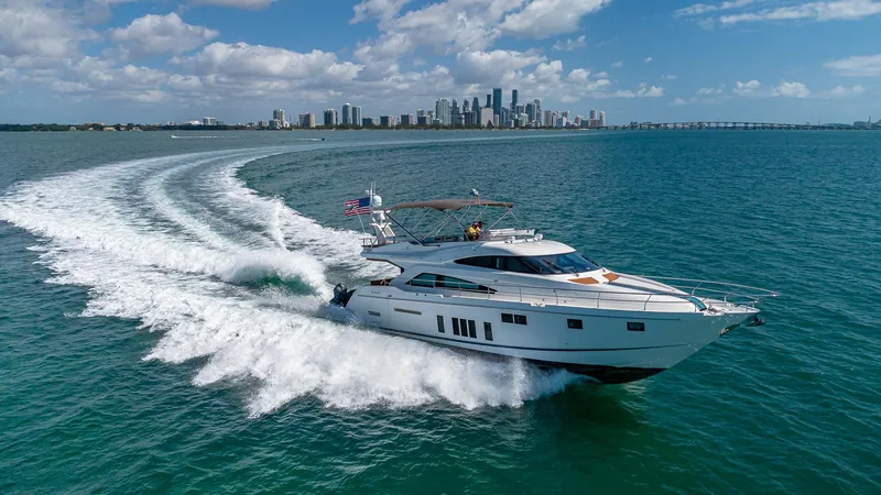 Blessed Yacht Photos Pics Fairline Squadron 65 yacht cruising near city skyline, 2015 model, under clear blue skies.
