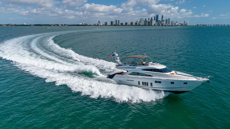 Blessed Yacht Photos Pics Fairline Squadron 65 yacht cruising on open water with city skyline in background, 2015 model.
