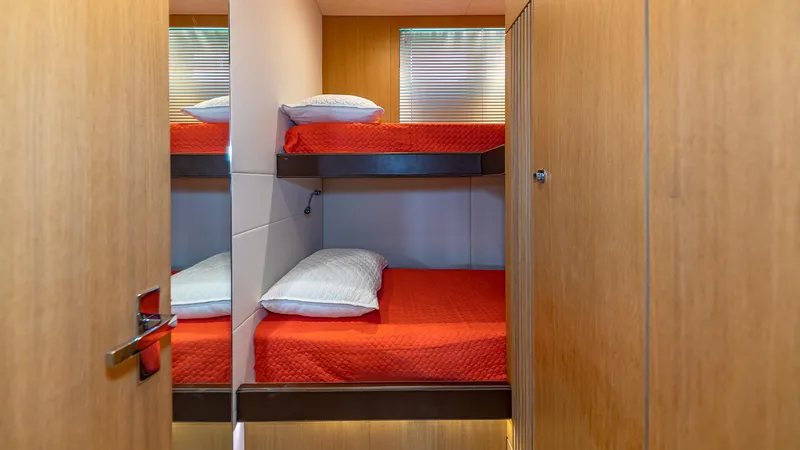 Blessed Yacht Photos Pics Bunk beds with red bedding in 2015 Fairline Squadron 65 yacht cabin.