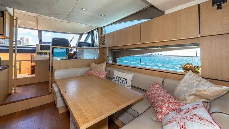 Blessed Yacht Photos Pics Luxurious interior of 2015 Fairline Squadron 65 yacht with elegant seating and sea view.