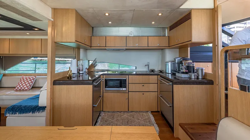 Blessed Yacht Photos Pics Luxurious kitchen interior of 2015 Fairline Squadron 65 yacht with modern appliances.