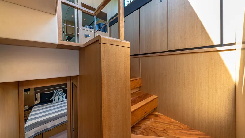 Blessed Yacht Photos Pics Interior of 2015 Fairline Squadron 65 yacht, featuring wooden stairs and modern design elements.