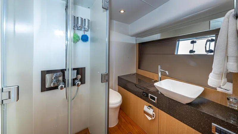 Blessed Yacht Photos Pics Luxurious bathroom in 2015 Fairline Squadron 65 yacht with modern fixtures and elegant design.
