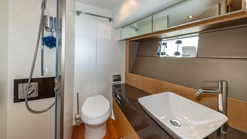 Blessed Yacht Photos Pics Luxury bathroom in 2015 Fairline Squadron 65 yacht with modern fixtures and sleek design.