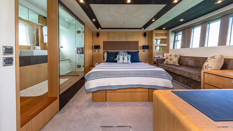 Blessed Yacht Photos Pics Luxurious Fairline Squadron 65 yacht bedroom interior, 2015 model, featuring modern design and elegant furnishings.